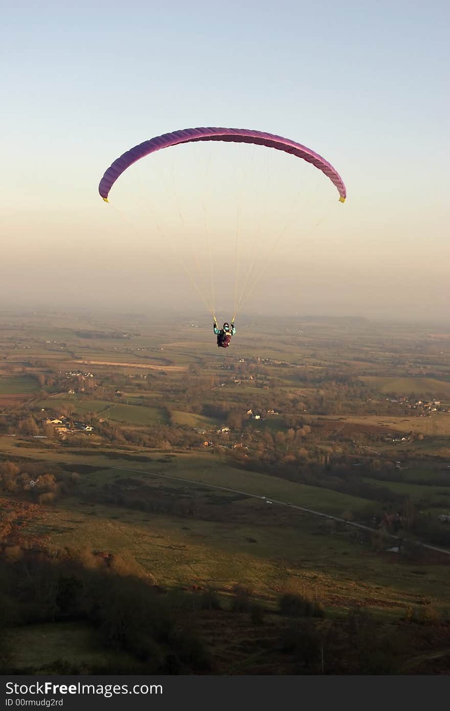 A Paraglider takes off for his last flight as the light fades over the Malvern Hills in Worcestershire, UK.