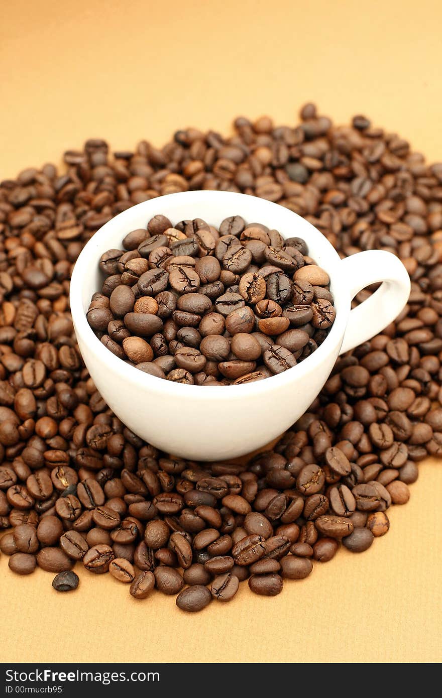 White coffee cup with coffee beans on yellow background