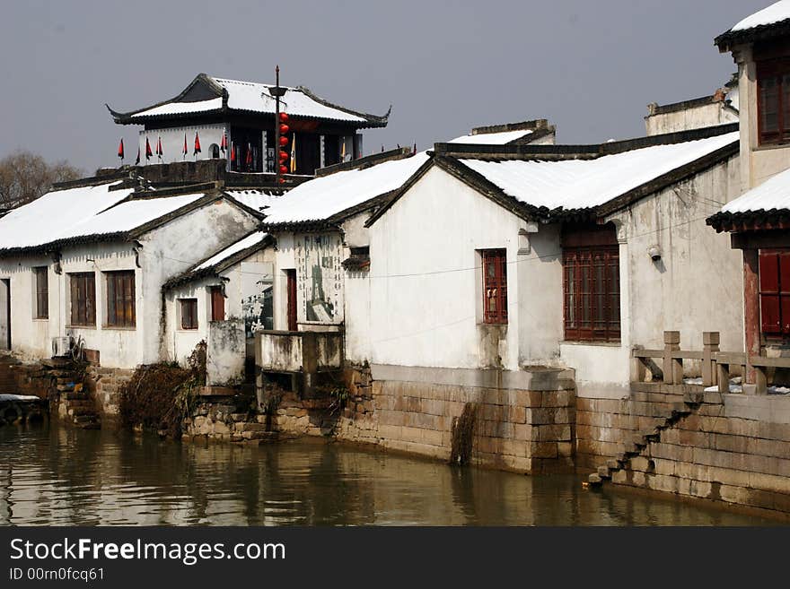 The beautiful and enjoyable snow scenery in the winter in the southern part of China. These sceneries are famous for their snow ,water, houses,and the blue sky.They are typical of the south in China.This picture is taken in the place of interest“Mooring by the Feng Bridge at night” in Suzhou ,China.