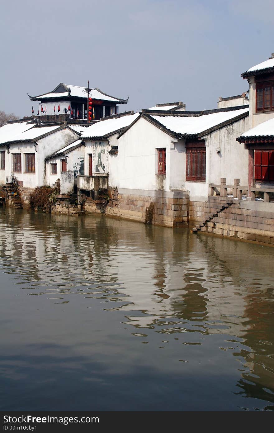 The beautiful and enjoyable snow scenery in the winter in the southern part of China. These sceneries are famous for their snow ,water, houses,and the blue sky.They are typical of the south in China.This picture is taken in the place of interest“Mooring by the Feng Bridge at night” in Suzhou ,China.