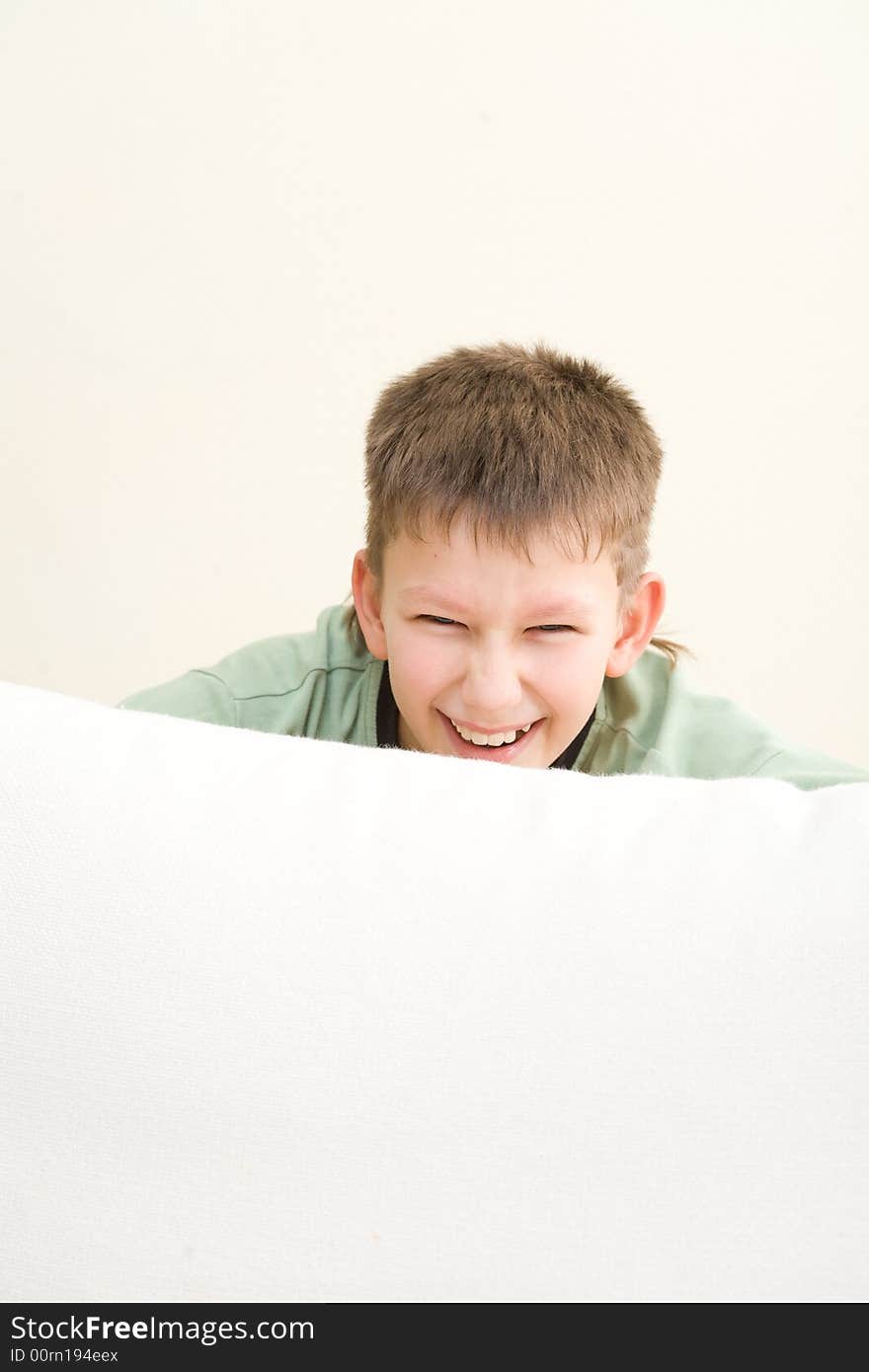 Happy teenager lie on sofa at home