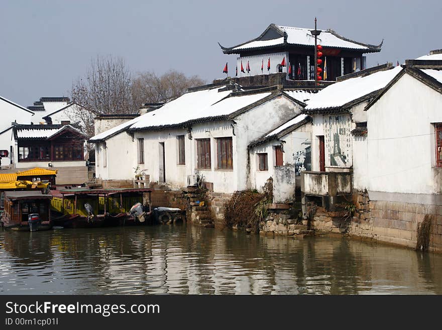 The beautiful and enjoyable snow scenery in the winter in the southern part of China. These sceneries are famous for their snow ,water, houses,and the blue sky.They are typical of the south in China.This picture is taken in the place of interest“Mooring by the Feng Bridge at night” in Suzhou ,China.