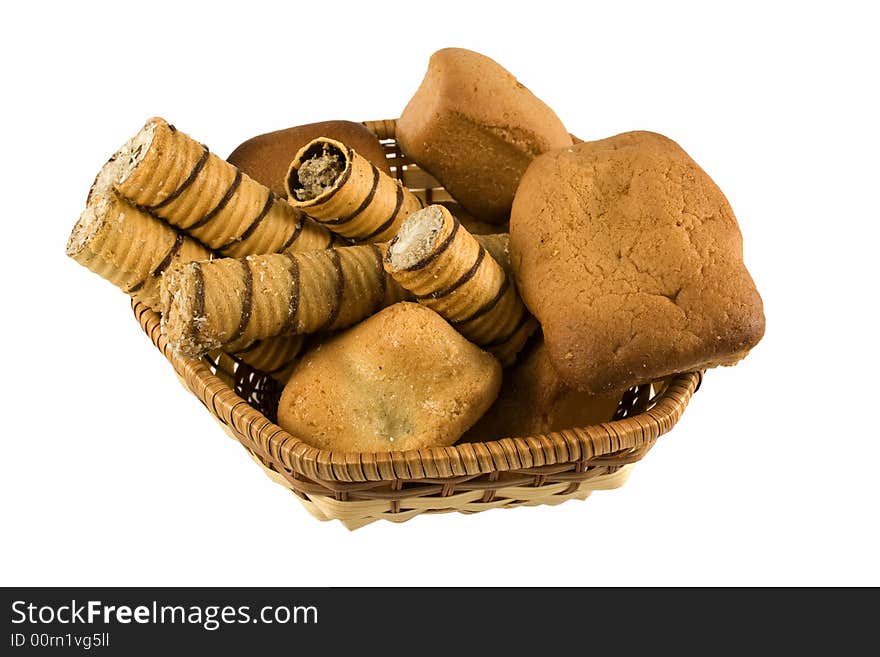 An isolated basket full of bakery foods. An isolated basket full of bakery foods