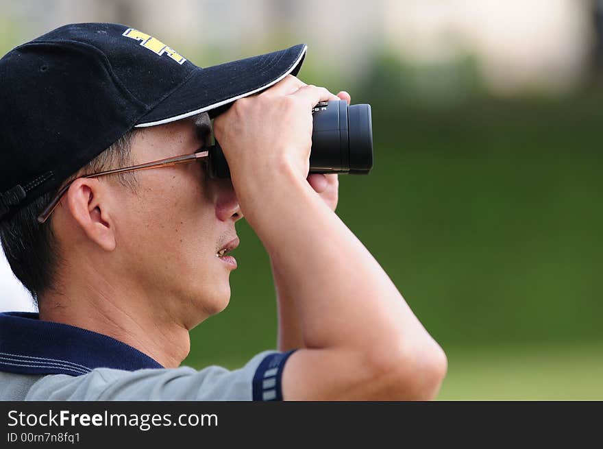 Chinese Man Looking Through Binoculars