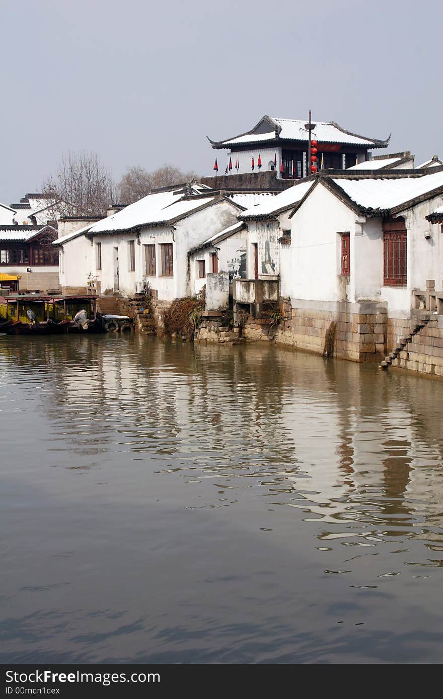 The beautiful and enjoyable snow scenery in the winter in the southern part of China. These sceneries are famous for their snow ,water, houses,and the blue sky.They are typical of the south in China.This picture is taken in the place of interest“Mooring by the Feng Bridge at night” in Suzhou ,China.