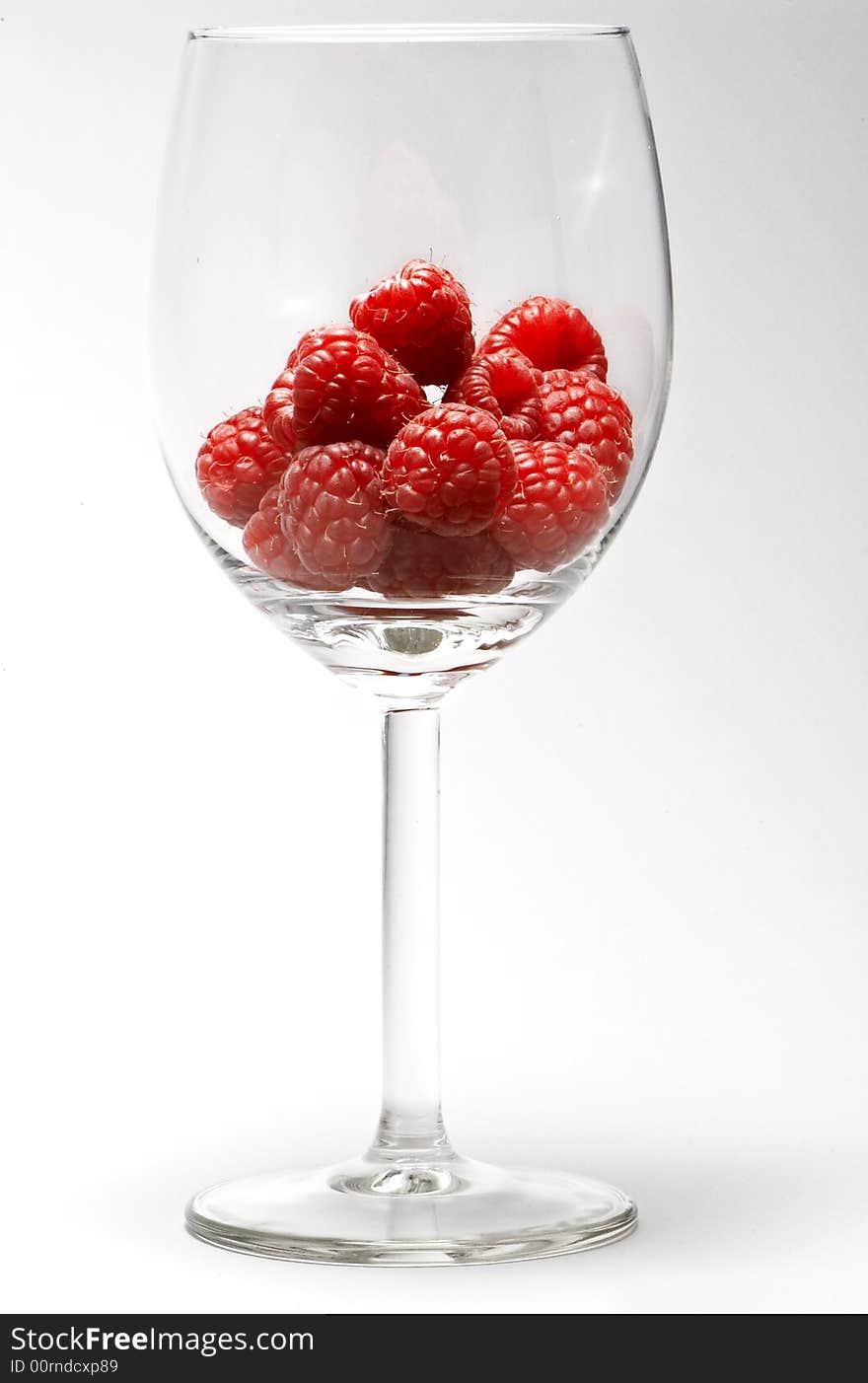 Raspberries on a transparent cup. Raspberries on a transparent cup