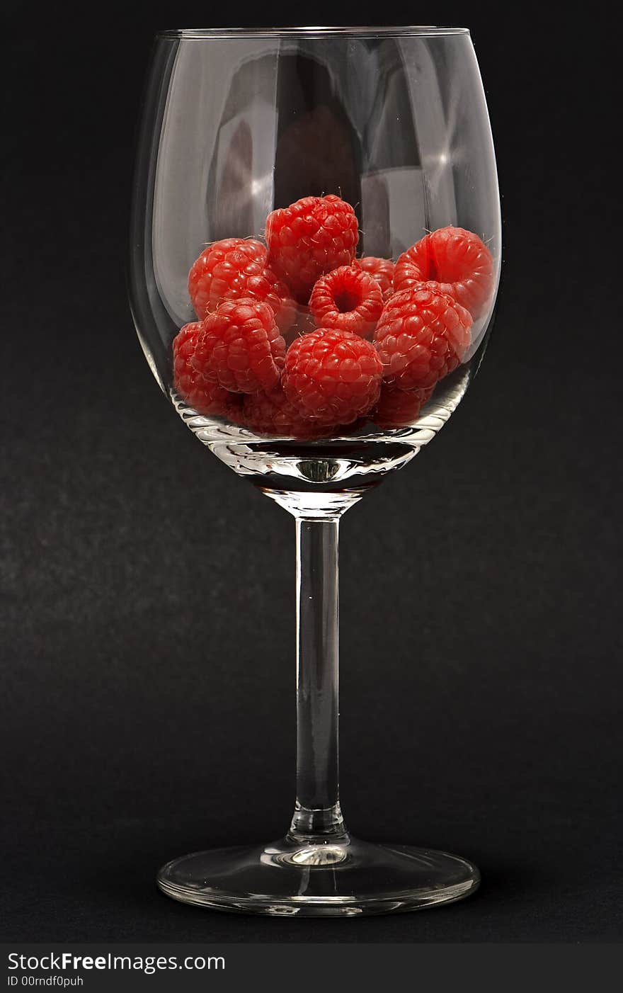 Raspberries on a transparent cup