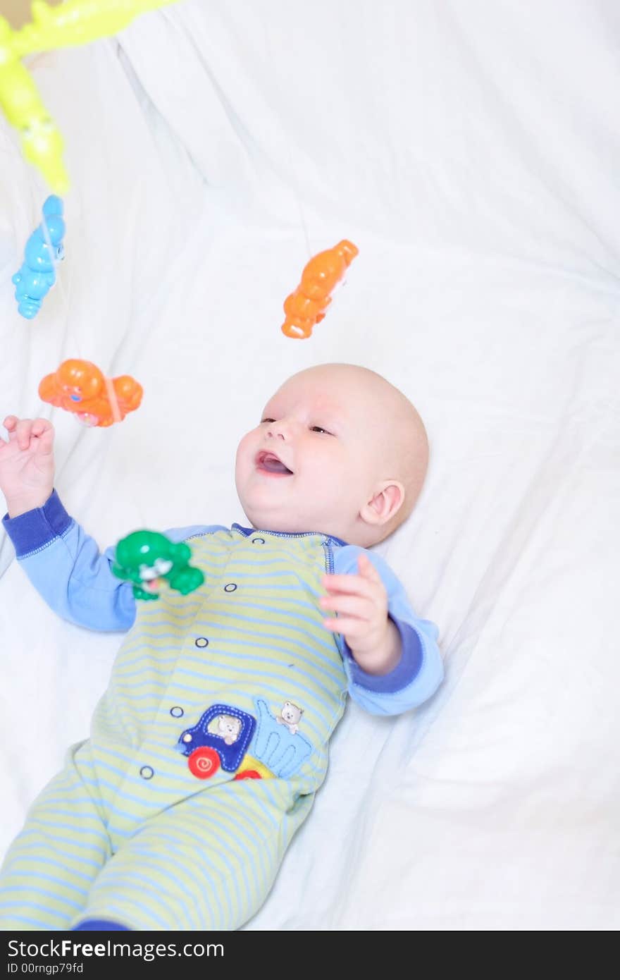 Baby playing with toys. Little boy touching the toys by finger. Baby playing with toys. Little boy touching the toys by finger