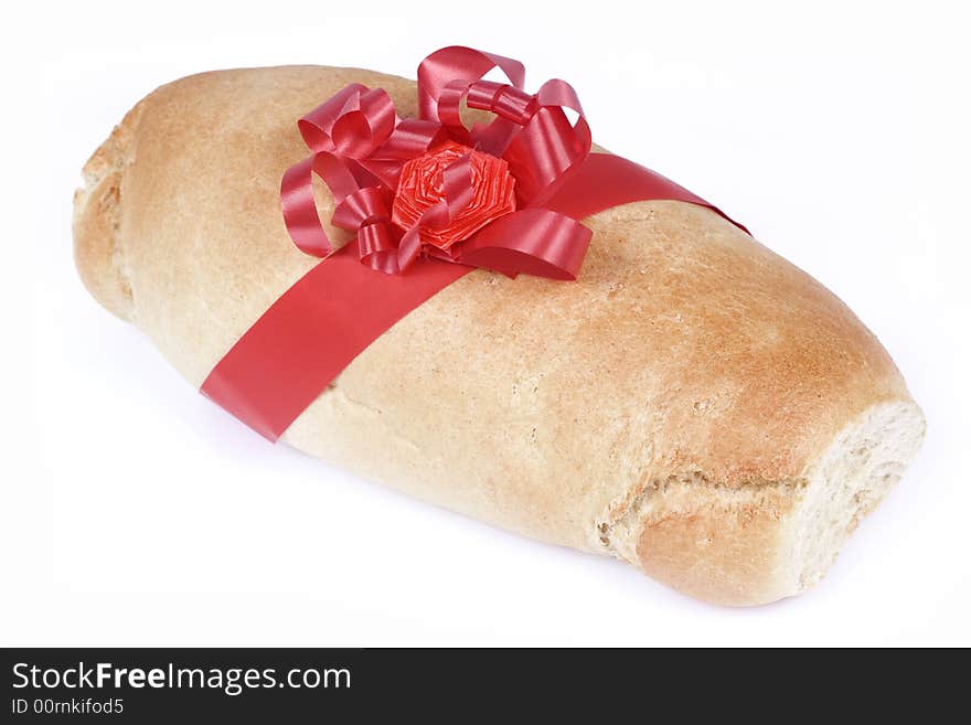 Loaf and red ribbon isolated on white background