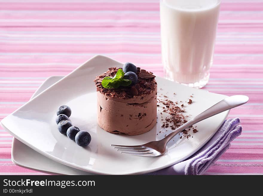 Chocolate Moose dessert on a white plate with milk