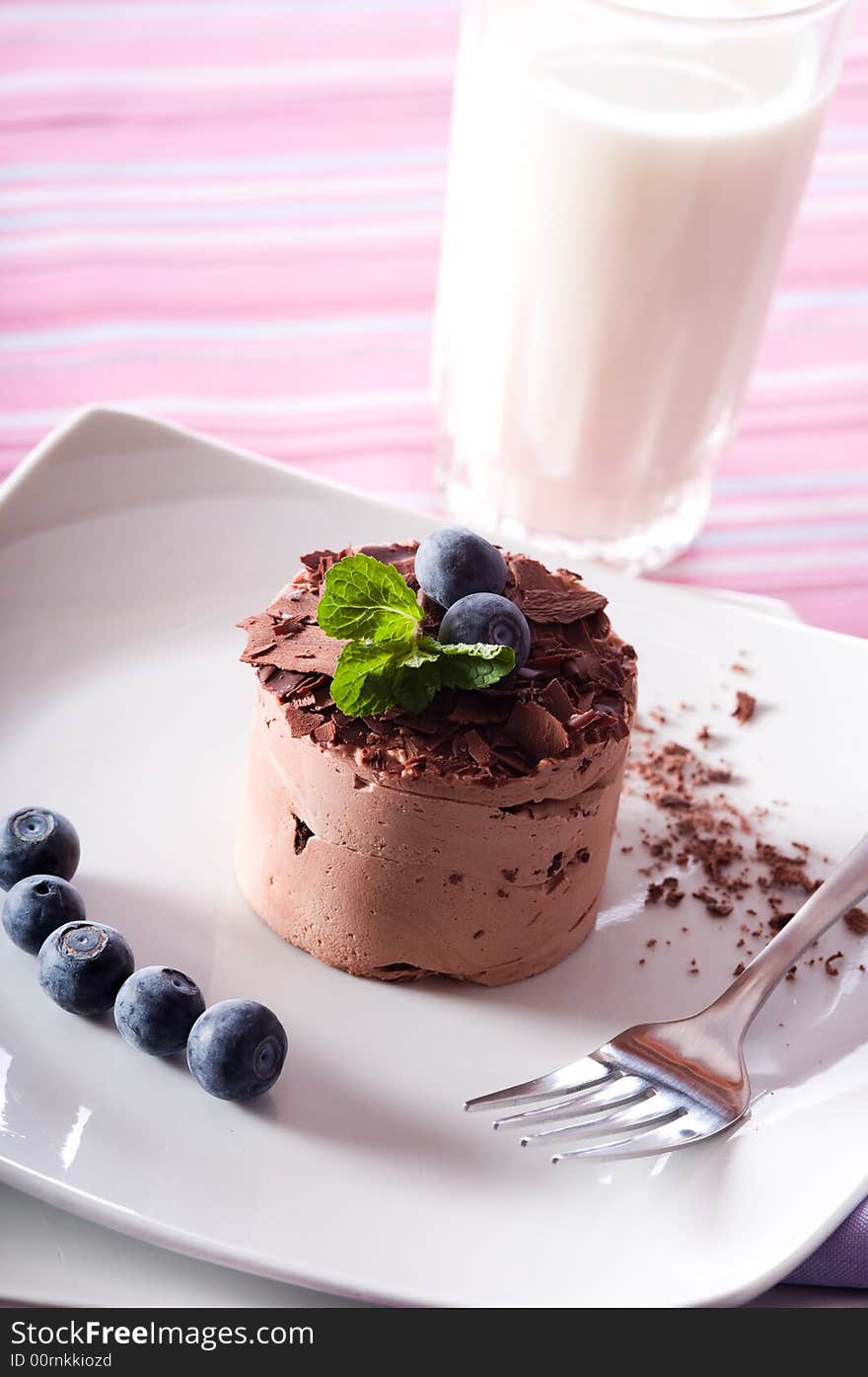 Chocolate Moose dessert on a white plate with milk