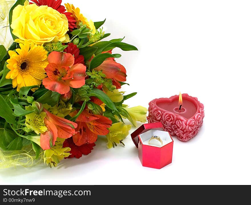 Still-life with a bouquet of flowers, a candle and a ring with sapphire on white background. Still-life with a bouquet of flowers, a candle and a ring with sapphire on white background.