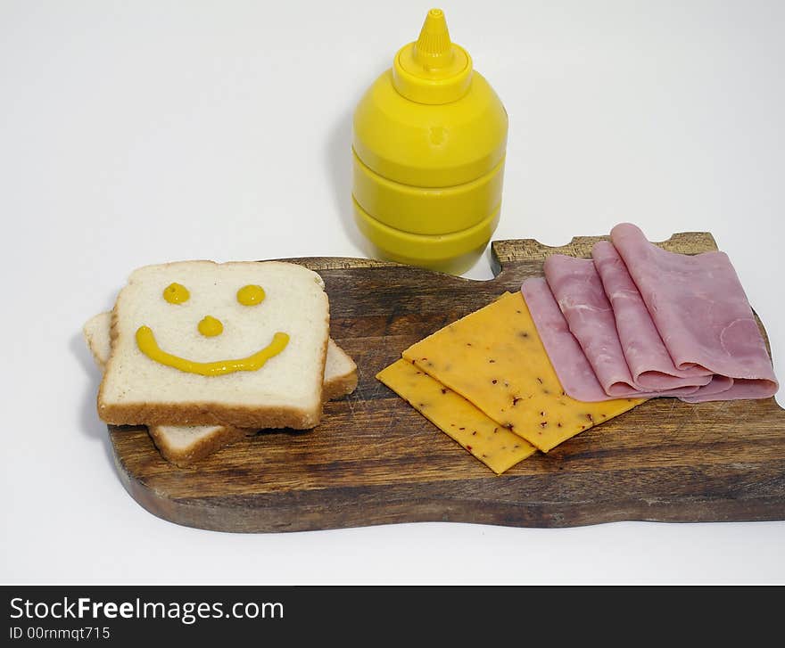 The makings of a hame and cheese
sandwich, with mustard. The makings of a hame and cheese
sandwich, with mustard.