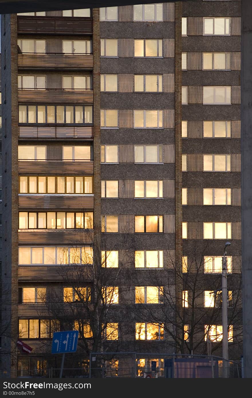 Many storey building with sunset reflection in windows. Many storey building with sunset reflection in windows