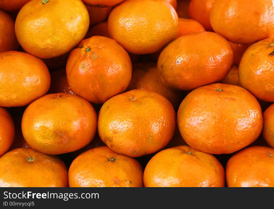 Organic Oranges stacked high in a market