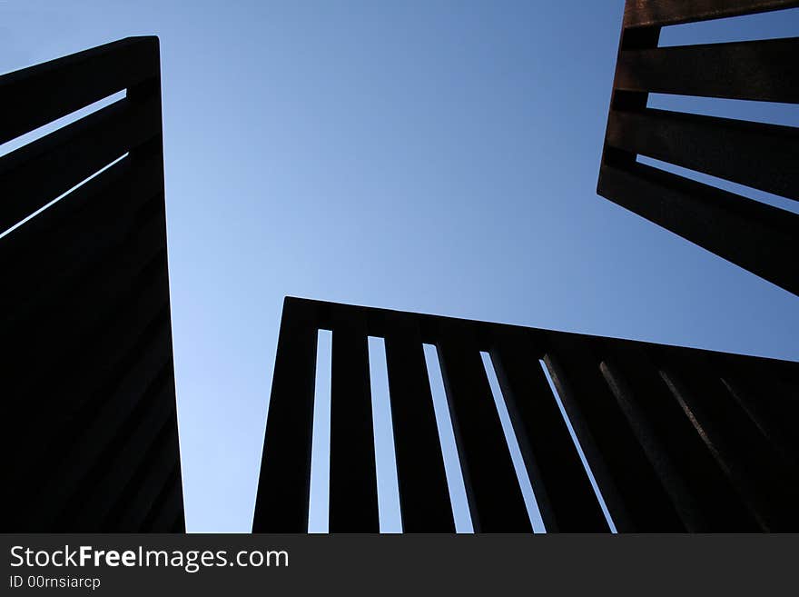 Scuptulral metal fence against blue sky. Scuptulral metal fence against blue sky