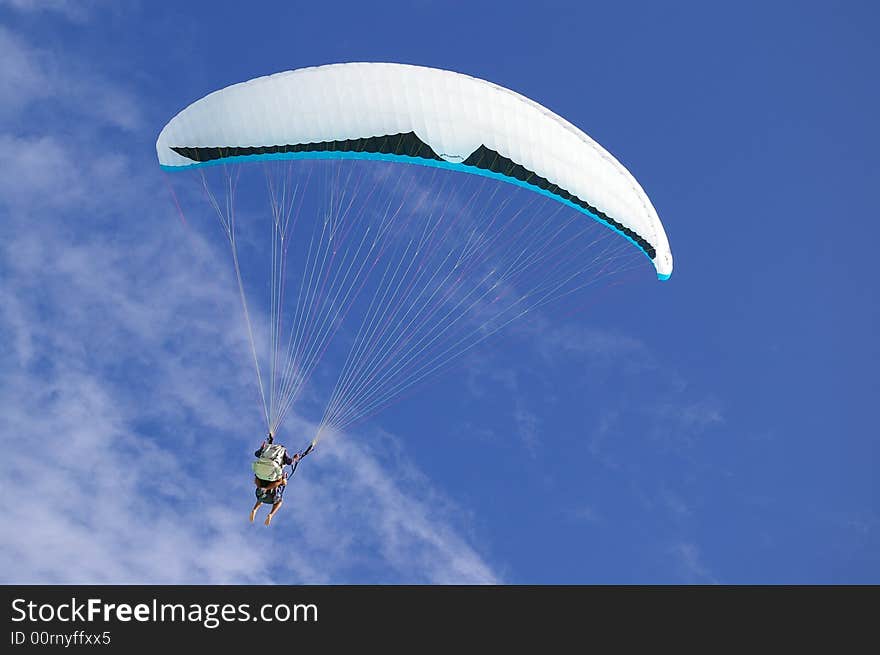 Para sail taking flight against a tranquil tropical blue sky background. Para sail taking flight against a tranquil tropical blue sky background