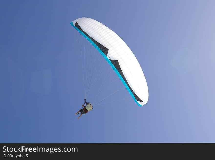 Para sail taking flight against a tranquil tropical blue sky background. Para sail taking flight against a tranquil tropical blue sky background