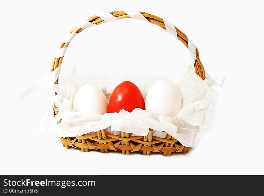 Basket with white and red eggs isolated on white. Basket with white and red eggs isolated on white