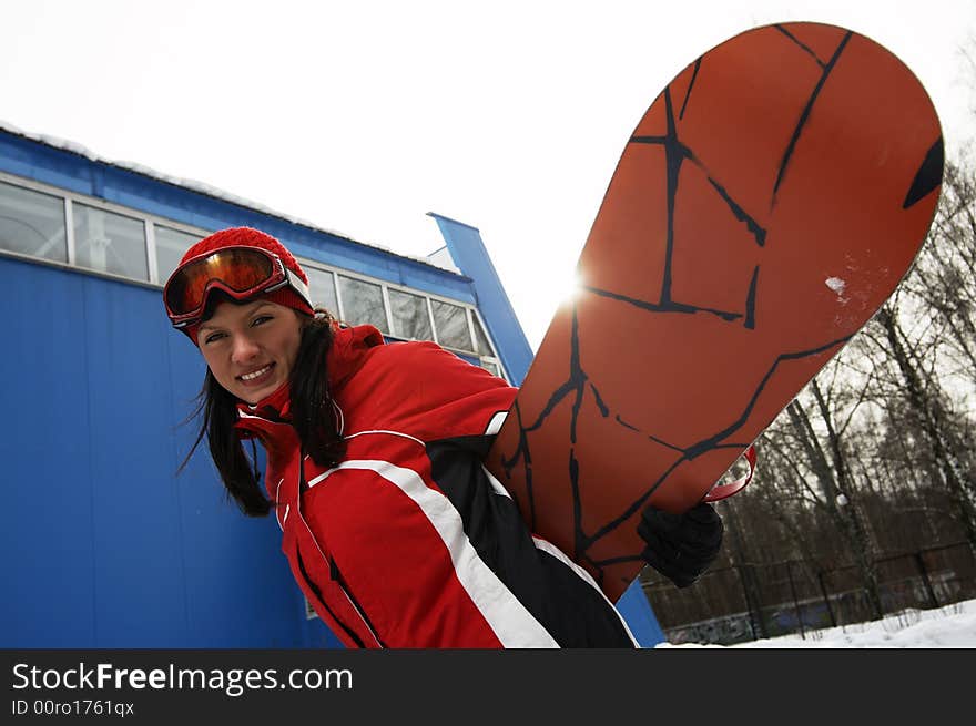 A lifestyle image of a young adult female (age 20-25) snowboarder. A lifestyle image of a young adult female (age 20-25) snowboarder.