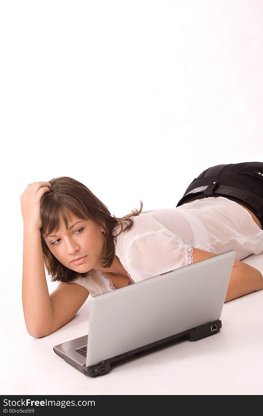 Pretty girl working on laptop isolated over white. Pretty girl working on laptop isolated over white