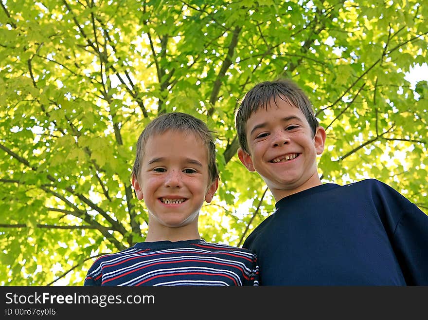 Brothers Standing in Front of a Tree