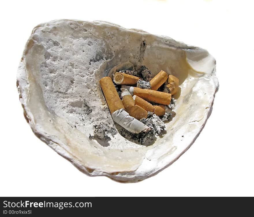 Cigarette butt in the shell ashtray