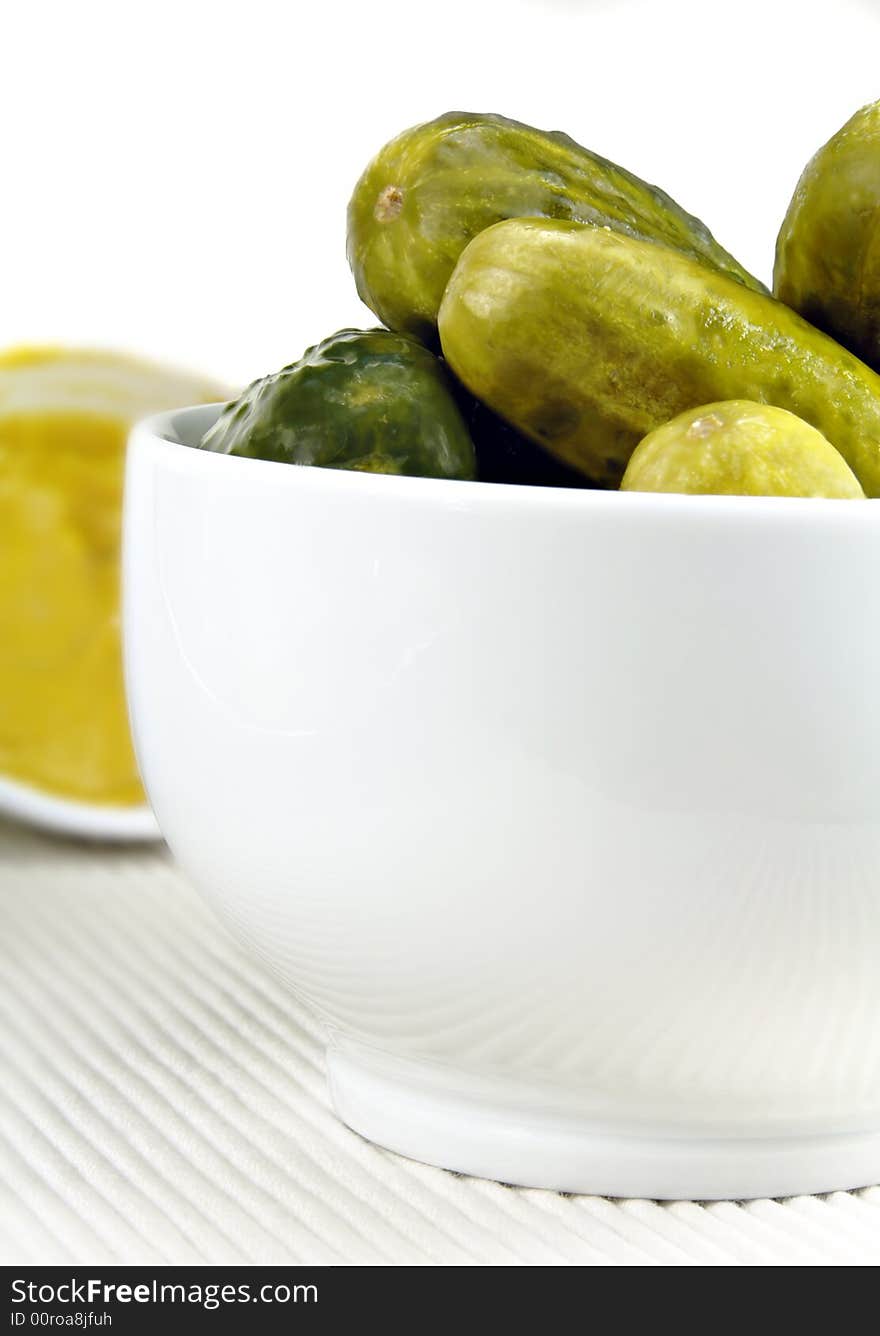 Pickled cucumbers arranged in a white dish. Pickled cucumbers arranged in a white dish.