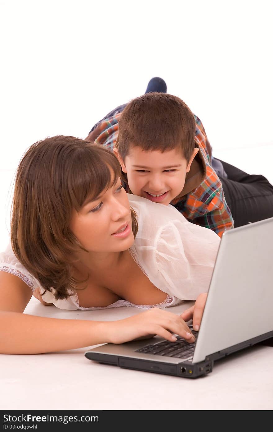 Mother and son playing with laptop over white background. Mother and son playing with laptop over white background