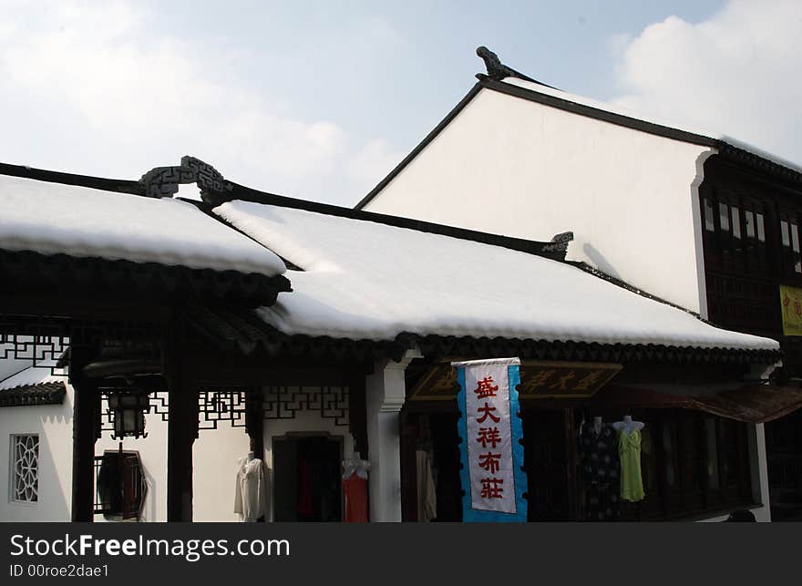 The beautiful and enjoyable snow scenery in the winter in the southern part of China. These sceneries are famous for their snow ,water, houses,and the blue sky.They are typical of the south in China.This picture is taken in the place of interest“Mooring by the Feng Bridge at night” in Suzhou ,China.