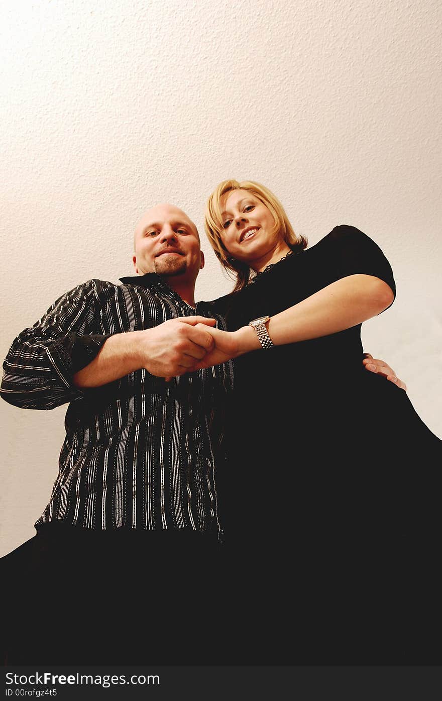 Young lovers standing in an studio for light blue background and the camera.
is lying on there feet. Young lovers standing in an studio for light blue background and the camera.
is lying on there feet.