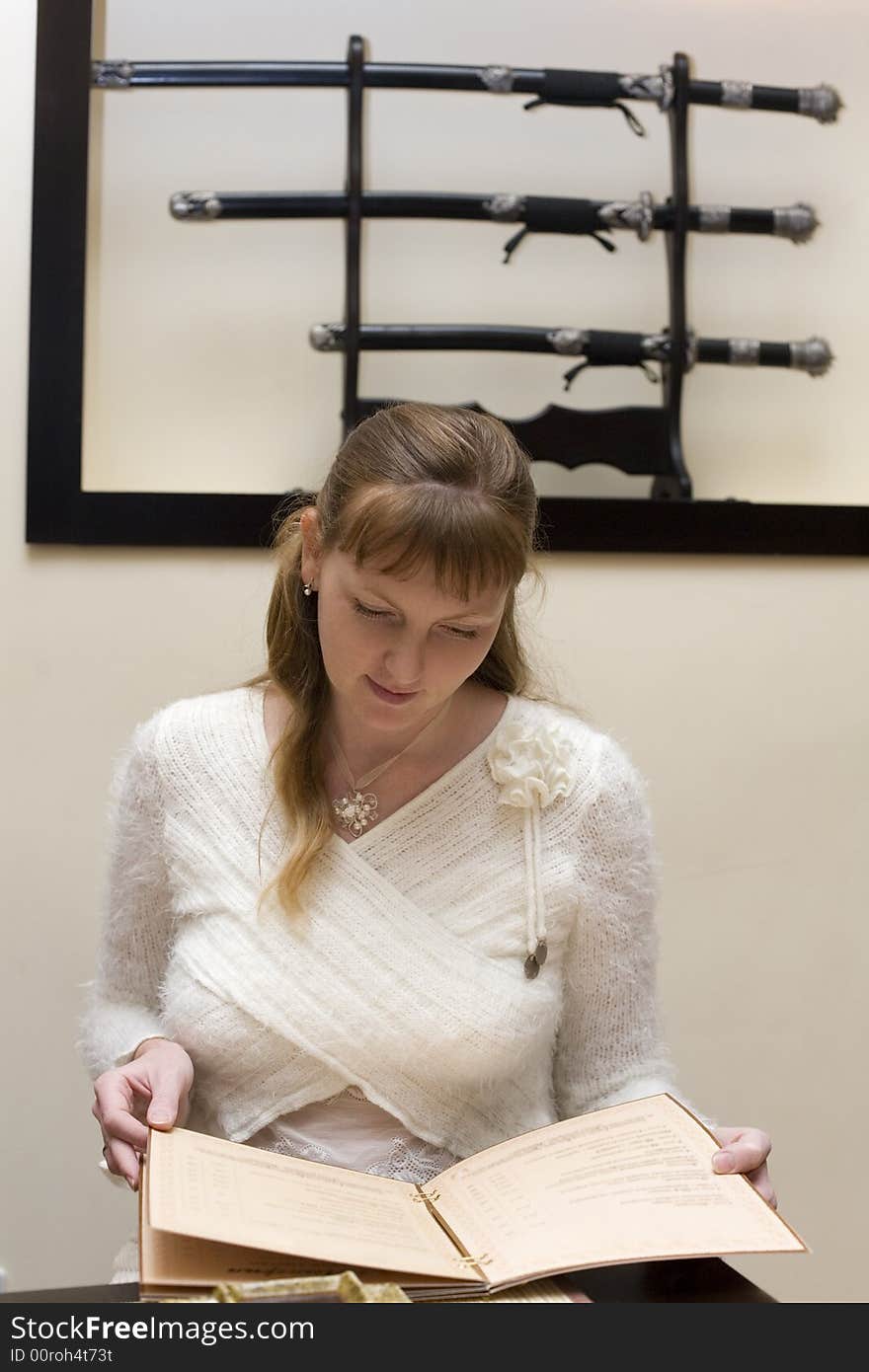 Woman choosing from menu in the japanese restaurant