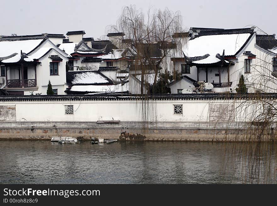 The beautiful and enjoyable snow scenery in the winter in the southern part of China. These sceneries are famous for their snow ,water, houses,and the blue sky.They are typical of the south in China.This picture is taken in the place of interest“Mooring by the Feng Bridge at night” in Suzhou ,China.