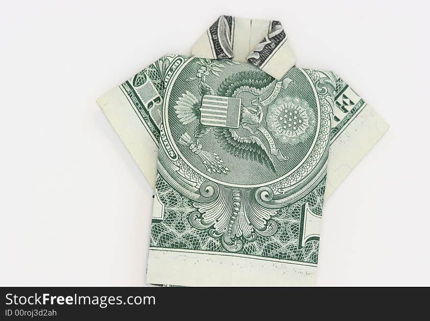 A US one dollar bill that has been folded into a shirt using origami on a white background. A US one dollar bill that has been folded into a shirt using origami on a white background.