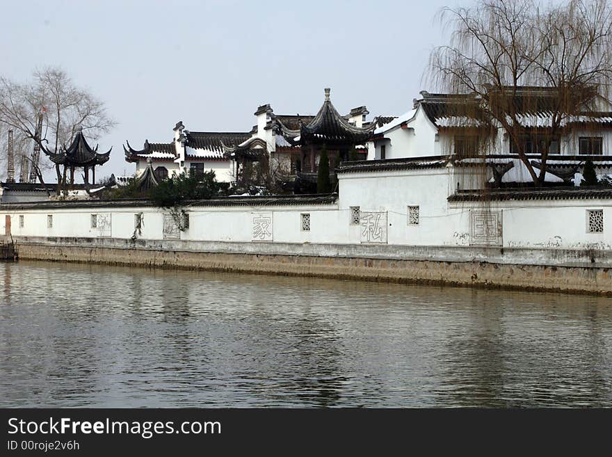 The beautiful and enjoyable snow scenery in the winter in the southern part of China. These sceneries are famous for their snow ,water, houses,and the blue sky.They are typical of the south in China.This picture is taken in the place of interest“Mooring by the Feng Bridge at night” in Suzhou ,China.