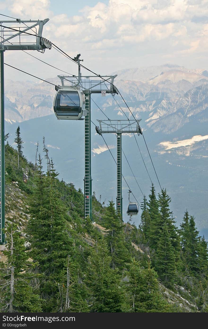 A line of gondolas climbing up into the mountains. A line of gondolas climbing up into the mountains