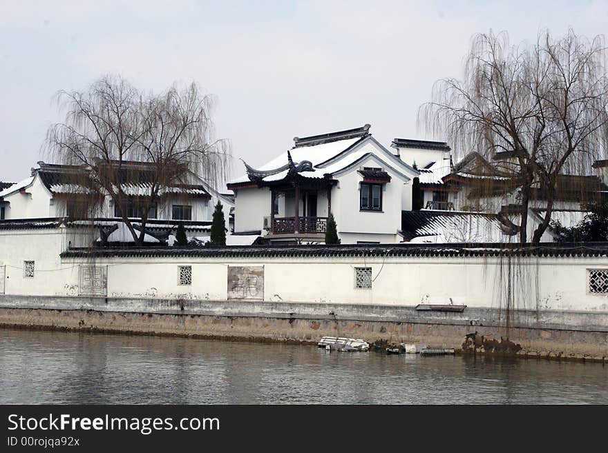 The beautiful and enjoyable snow scenery in the winter in the southern part of China. These sceneries are famous for their snow ,water, houses,and the blue sky.They are typical of the south in China.This picture is taken in the place of interest“Mooring by the Feng Bridge at night” in Suzhou ,China.