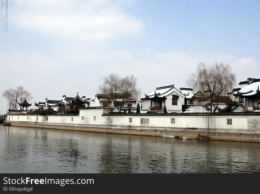 The beautiful and enjoyable snow scenery in the winter in the southern part of China. These sceneries are famous for their snow ,water, houses,and the blue sky.They are typical of the south in China.This picture is taken in the place of interest“Mooring by the Feng Bridge at night” in Suzhou ,China.