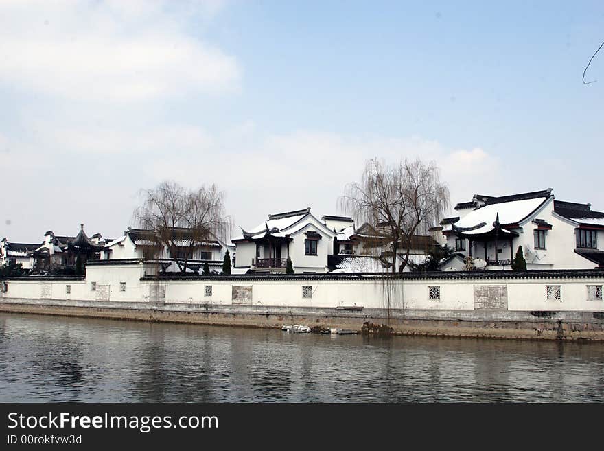 The beautiful and enjoyable snow scenery in the winter in the southern part of China. These sceneries are famous for their snow ,water, houses,and the blue sky.They are typical of the south in China.This picture is taken in the place of interest“Mooring by the Feng Bridge at night” in Suzhou ,China.