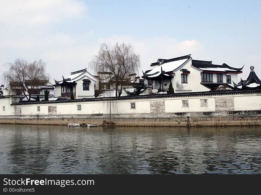 The beautiful and enjoyable snow scenery in the winter in the southern part of China. These sceneries are famous for their snow ,water, houses,and the blue sky.They are typical of the south in China.This picture is taken in the place of interest“Mooring by the Feng Bridge at night” in Suzhou ,China.