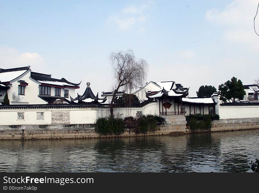 The beautiful and enjoyable snow scenery in the winter in the southern part of China. These sceneries are famous for their snow ,water, houses,and the blue sky.They are typical of the south in China.This picture is taken in the place of interest“Mooring by the Feng Bridge at night” in Suzhou ,China.