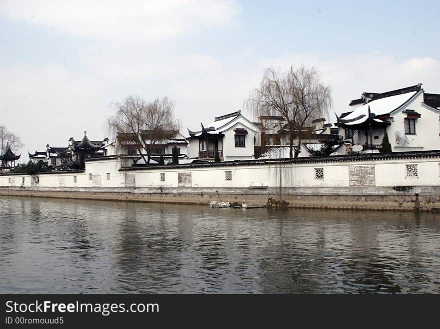 The beautiful and enjoyable snow scenery in the winter in the southern part of China. These sceneries are famous for their snow ,water, houses,and the blue sky.They are typical of the south in China.This picture is taken in the place of interest“Mooring by the Feng Bridge at night” in Suzhou ,China.