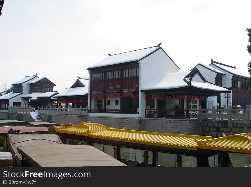 The beautiful and enjoyable snow scenery in the winter in the southern part of China. These sceneries are famous for their snow ,water, houses,and the blue sky.They are typical of the south in China.This picture is taken in the place of interest“Mooring by the Feng Bridge at night” in Suzhou ,China.