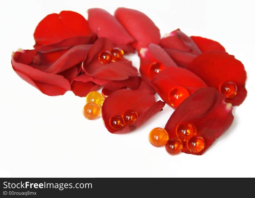 Red rose petals and pearls isolated on white