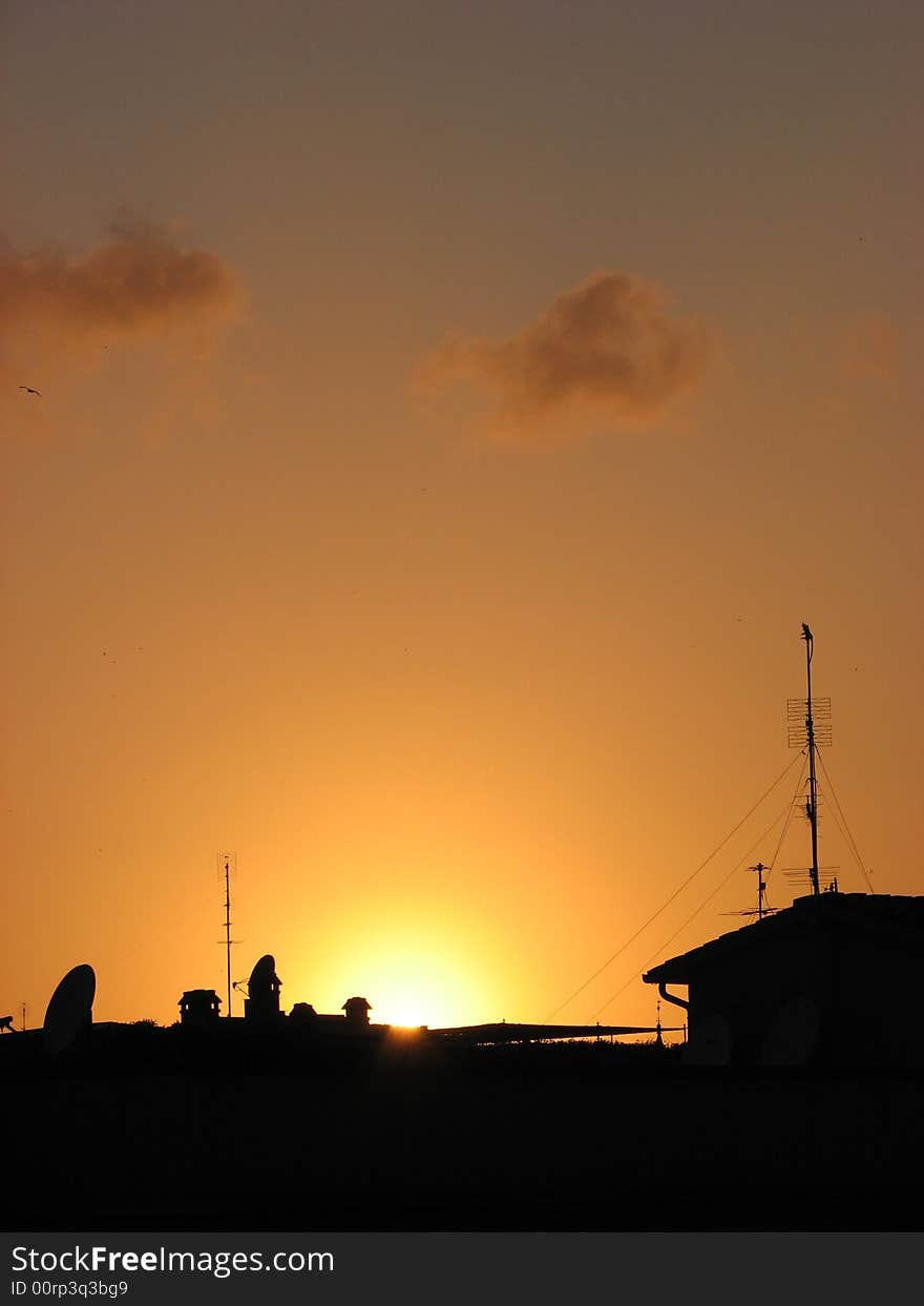 Sunset in the city over the roofs view