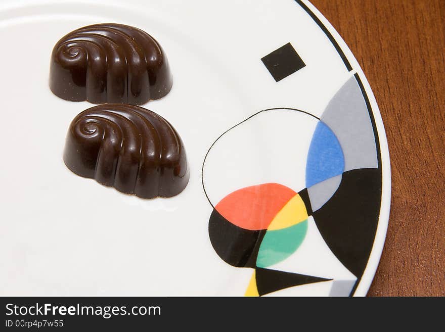 Chocolate candies on white plate