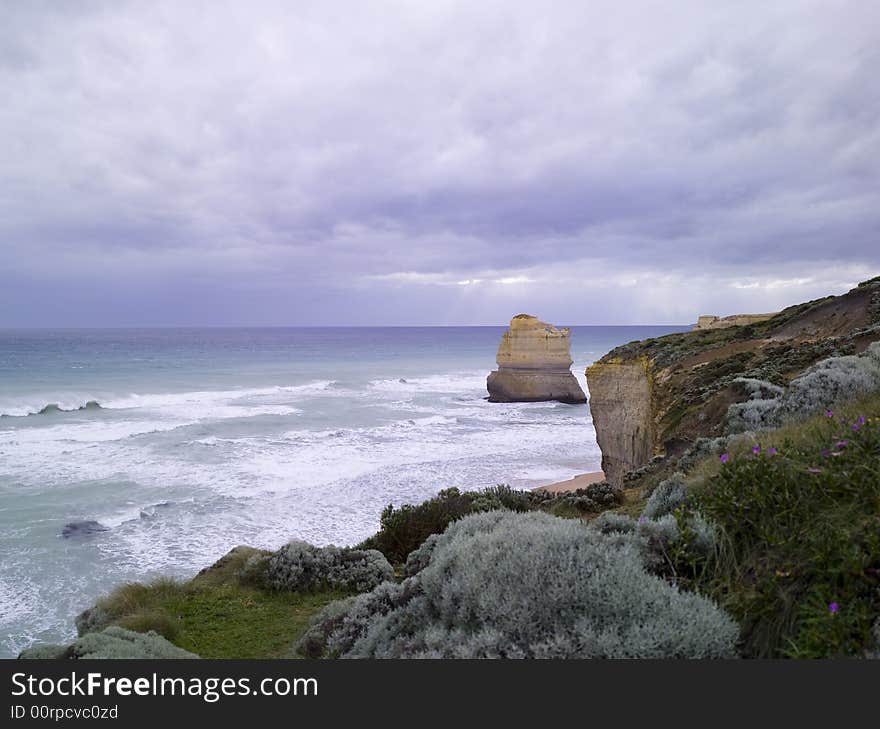 Eroded cliffs - stacks in ocean waves, Victoria, Australia. Eroded cliffs - stacks in ocean waves, Victoria, Australia