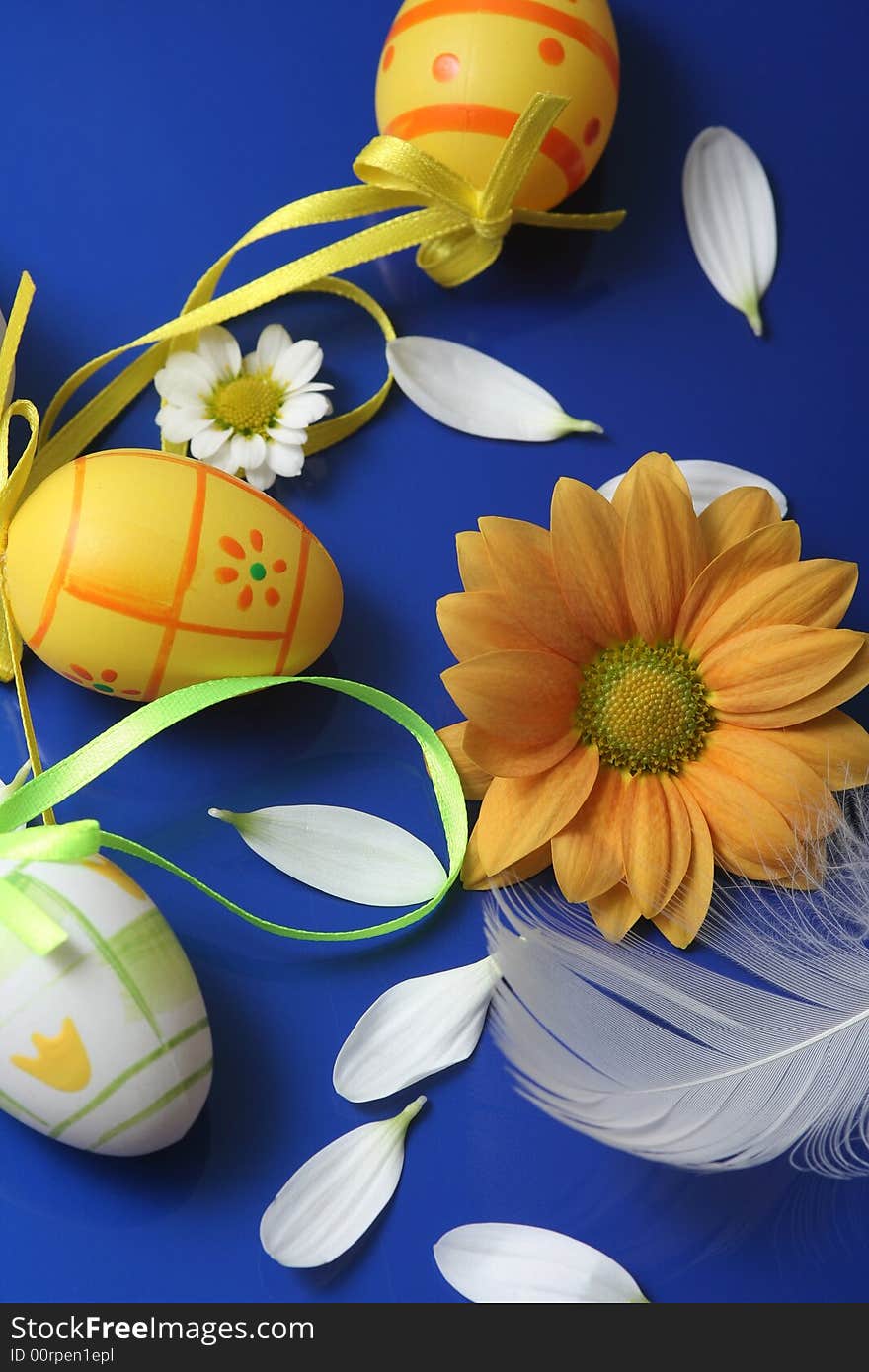 Easter eggs with flower on blue background.