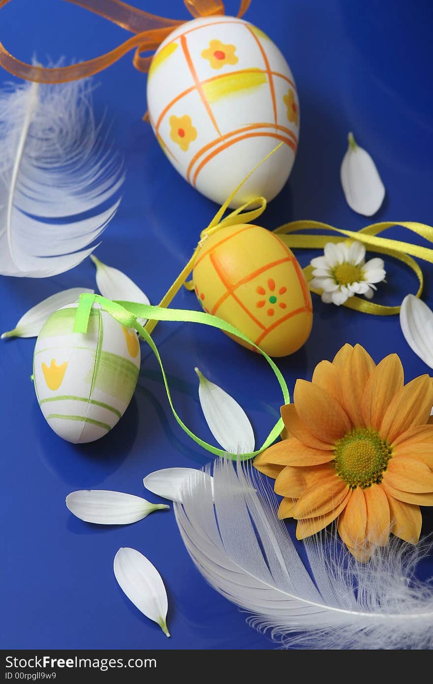 Easter eggs with flower on blue background.