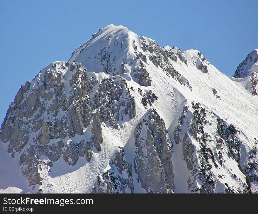 Winter in the Alps, beautiful mountain peak covered in snow on a beautiful sunny day. Winter in the Alps, beautiful mountain peak covered in snow on a beautiful sunny day